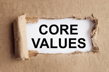 core values, text on white paper on torn paper