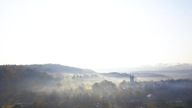 Aerial 4K footage: Flight over autumn mountain village of Breb in sunrise. Carpathian Mountains, Maramures, Romania.