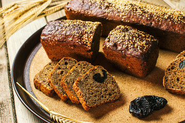 Sliced bread with dried plum is on the kitchen Board. Hand-made sourdough bread