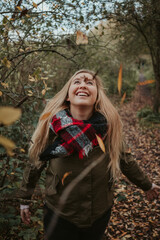 Girl in autumn forest nature with brown colors