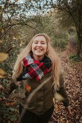 Girl in autumn forest nature with brown colors