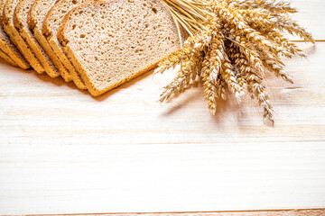 Traditional bread. Fresh loaf of rustic traditional bread with wheat grain ear or spike plant on...