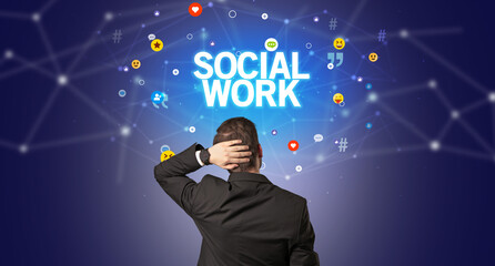 Rear view of a businessman with SOCIAL WORK inscription, social networking concept
