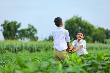 Fototapeta premium Cute indian child playing at green field
