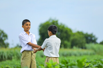 Cute indian child playing at green field