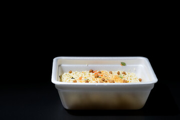 Dry instant noodles in rectangle plastic plate, top view