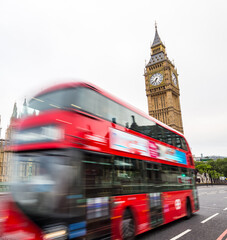Big Ben and red bus in motion in London