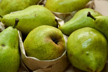 Pears background. Fresh pear fruit. Autumn fruits harvest on retro paper background. Organic farmers market products. Sweet, fresh and healthy food.