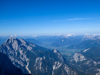 Fototapeta na wymiar A panoramic view on endless mountain chains from top of a mountain in Hochtor region, Austrian Alps. High Alpine mountaineering. Sunny, cloudless summer day. Exploring new places.