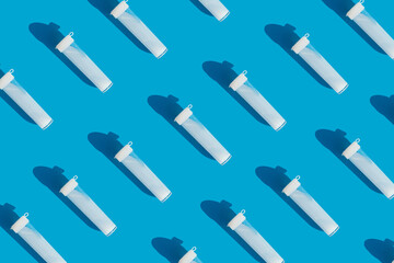 test tubes with sperm on a bright blue background. medical pattern. artificial insemination and conception. 