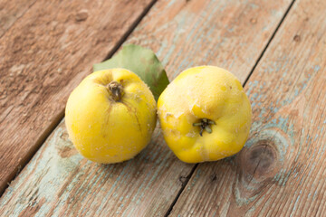 Quince, yellow ripe apple quince on wooden background