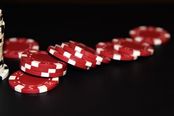 Red poker chips on a black background