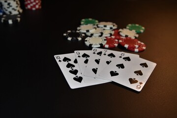Poker concept with winning hand of a straight flush in spades