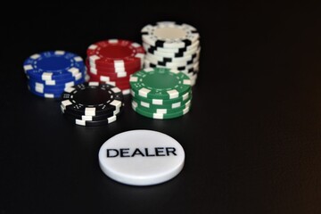 poker chips and dice with dealer button