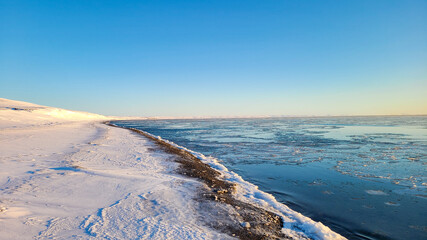 Arctic ocean starting to freeze at the shore line,  near Sachs Harbour on Banks Island Canada
