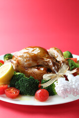 赤いバックで撮影したクリスマスの料理（チキンの丸焼き）