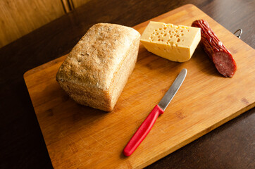 Making a sandwich of cheese bread and sausage. sandwich ingredients