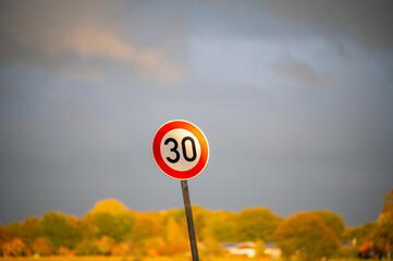 a thirties  zone sign with dark ominous clouds in the background