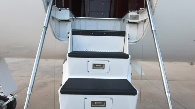 Entering a luxury private jet using the airplane stairs