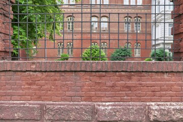 Urban old architecture background, vintage building and red brick fence