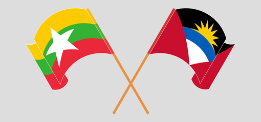Crossed and waving flags of Antigua and Barbuda and Myanmar