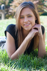 Healthy young teenage girl in meadow and grass.