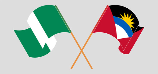 Crossed and waving flags of Antigua and Barbuda and Nigeria