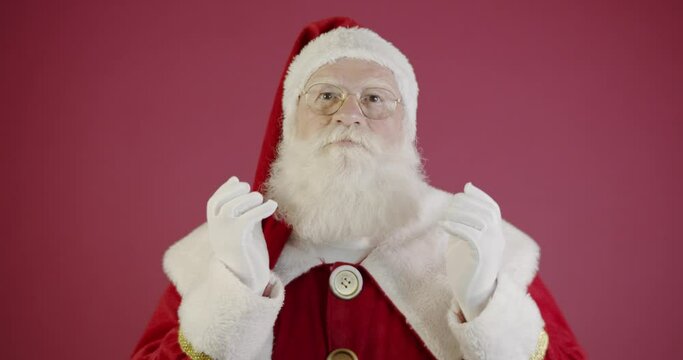 Santa Claus touching his long white beard. 4K.