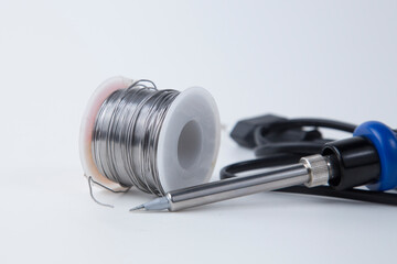 Solder for soldering with a soldering iron in a Bay on a white background.