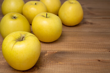 Yellow Golden apples on wood background. Juicy and sweet fruits.