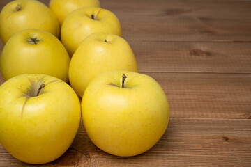 Yellow ripe Golden apples on wood background. Tasty and sweet fruits.