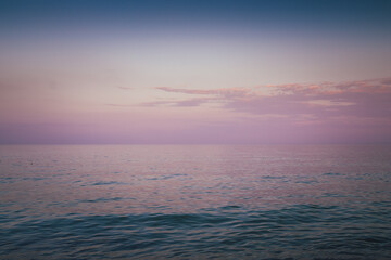 Sky in the pink, blue and purple colors sky at sunset. Blue hour after sunset on the sea. Beautiful clouds on the horizon