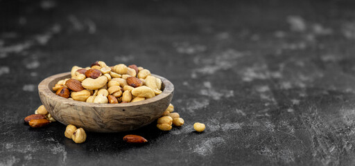 Fototapeta na wymiar Portion of roasted nuts (close up; selective focus)