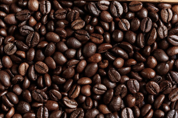 closeup of perfect Roasted coffee beans background. Food ingredients, top view, space for text. Soft selective focus.