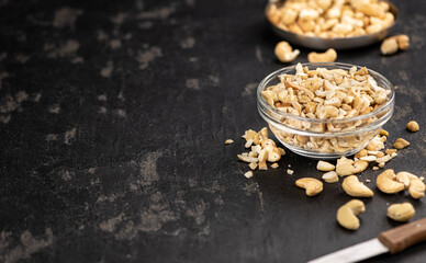Slate slab with chopped Cashew nuts (close-up shots, selective focus)