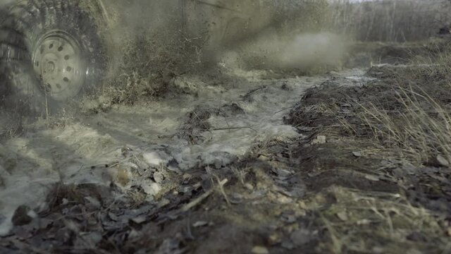 Offroad car on bad road. Off road jeep expedition. Mud splash in off-road racing. Jeep tour. Four wheel drive off road.