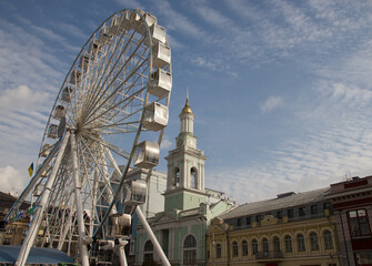 UKRAINE. KYIV - 24 OCTOBER 2020. A view of the old Bell Tower next to the modern ferris wheel, the...