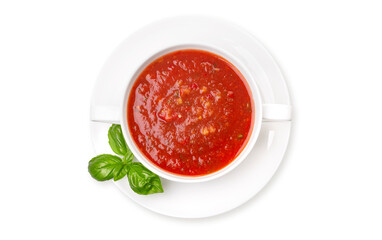 Gazpacho in a white plate and basil