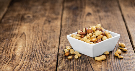Portion of roasted nuts (close up; selective focus)