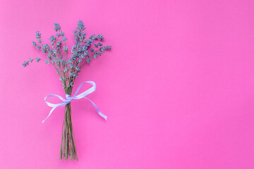 Bunch of dried lavender flowers on purple background.
