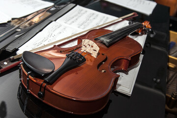 Violin lying on piano. Music instrument.