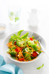 Fresh raw vegetable salad with boiled broccoli, greens and vegetables