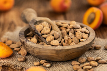 Vintage wooden table with shelled Apricot Kernels (selective focus)