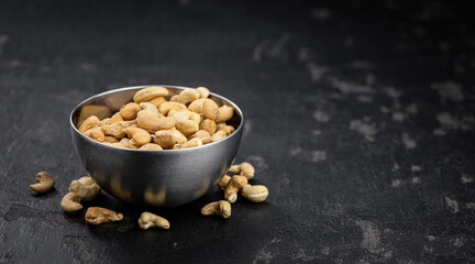 Some roasted Cashew Nuts (close up; selective focus)