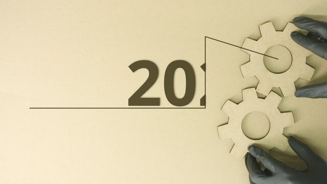 Cardboard cog wheels and 2023 text on the table