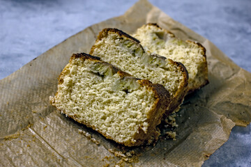 Homemade Vegan Gluten Free Banana Bread Sugar Free. Oatmeal bread with banana, honey and nuts in a baking dish on a gray table surrounded by ingredients. Top view, flat lay. Healthy sweets concept