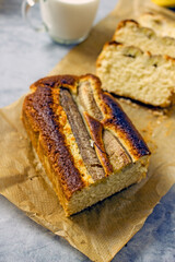 Homemade Vegan Gluten Free Banana Bread Sugar Free. Oatmeal bread with banana, honey and nuts in a baking dish on a gray table surrounded by ingredients. Top view, flat lay. Healthy sweets concept