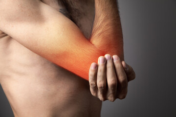 Fototapeta premium The man is holding hands. Elbow pain