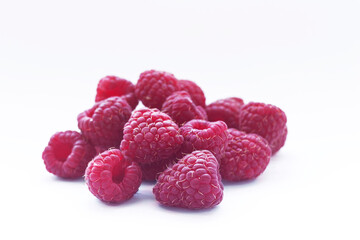Fresh raspberry isolated over white background. Close up macro shot. Selective focus.