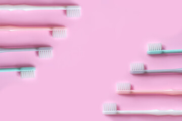 toothbrush in pastel colors on pink background .copy  space  flat lay .
